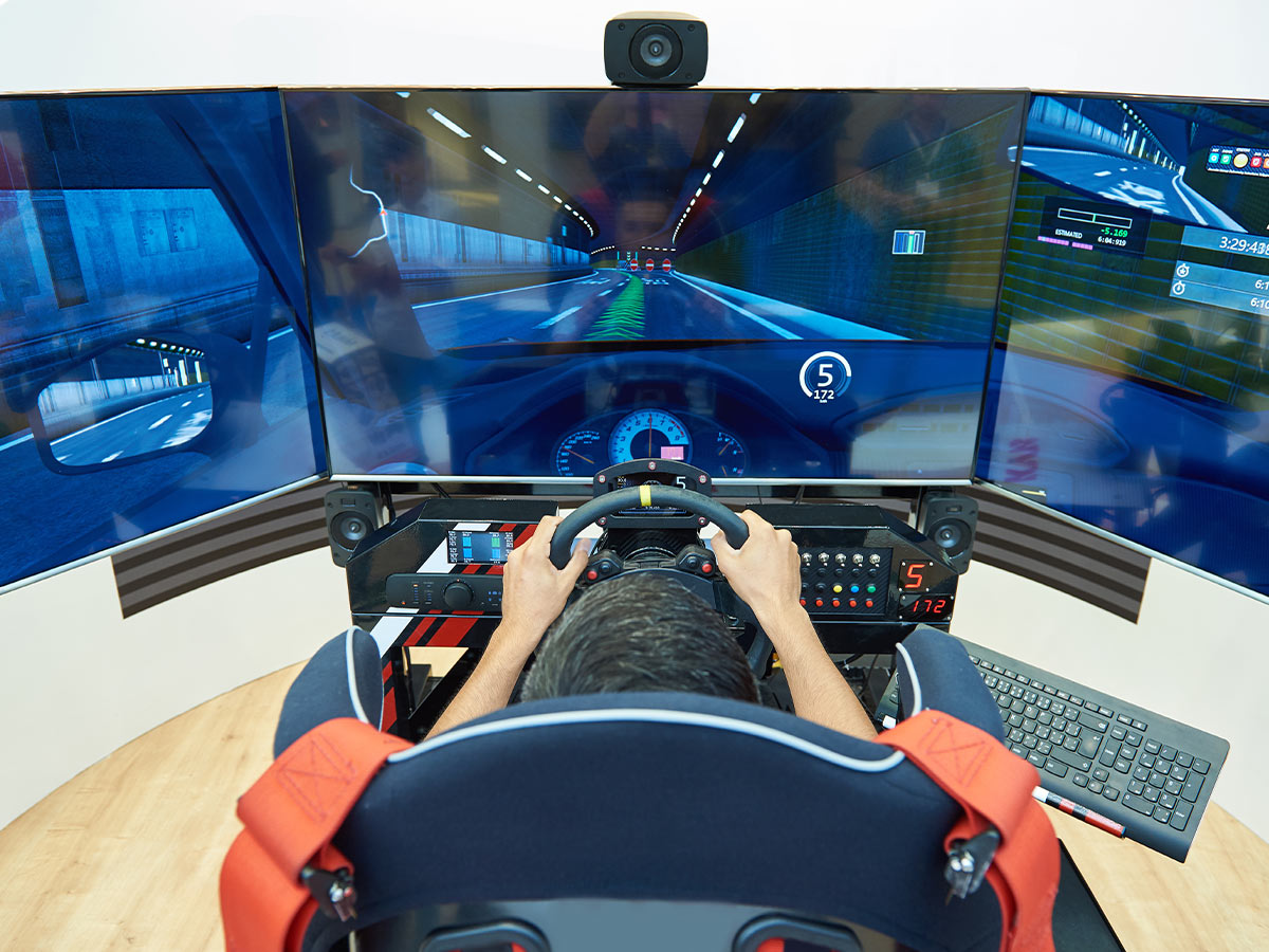 Image of someone playing a racing game in a game simulator